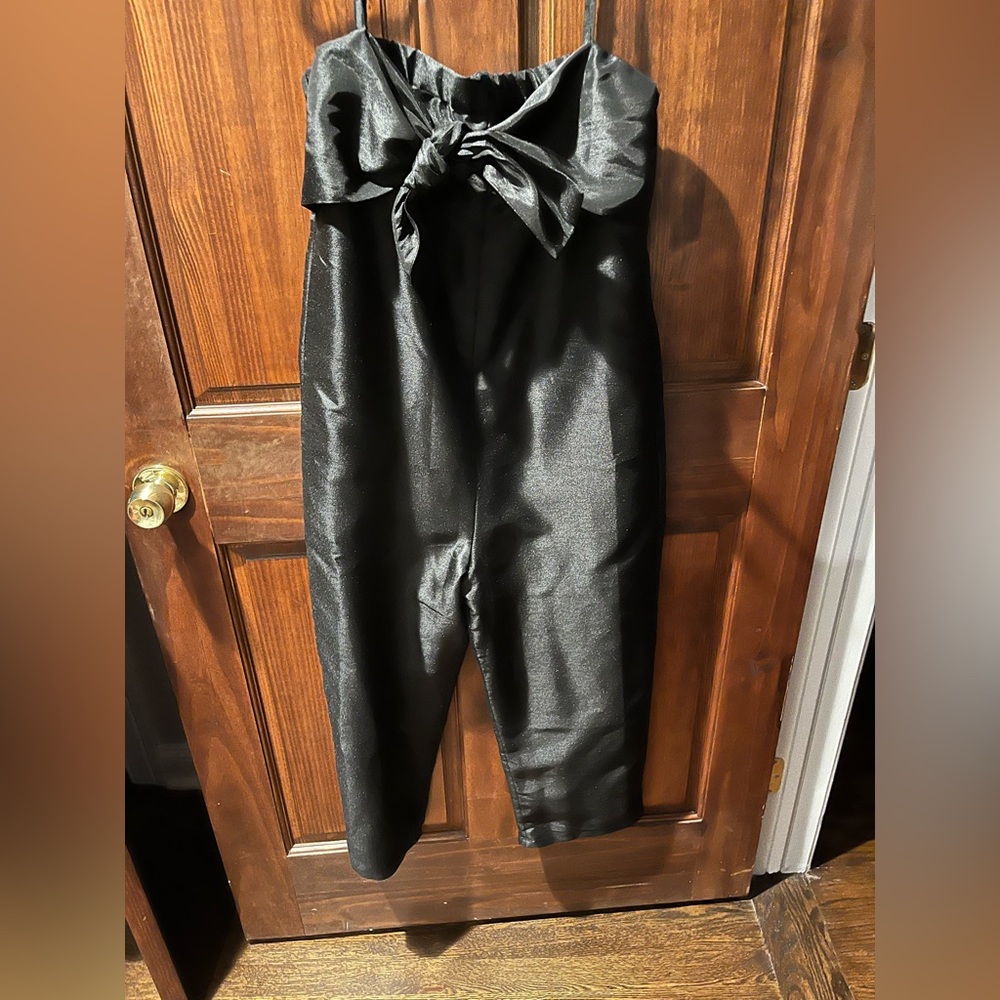 Black jumpsuit, with bow front. Stretch